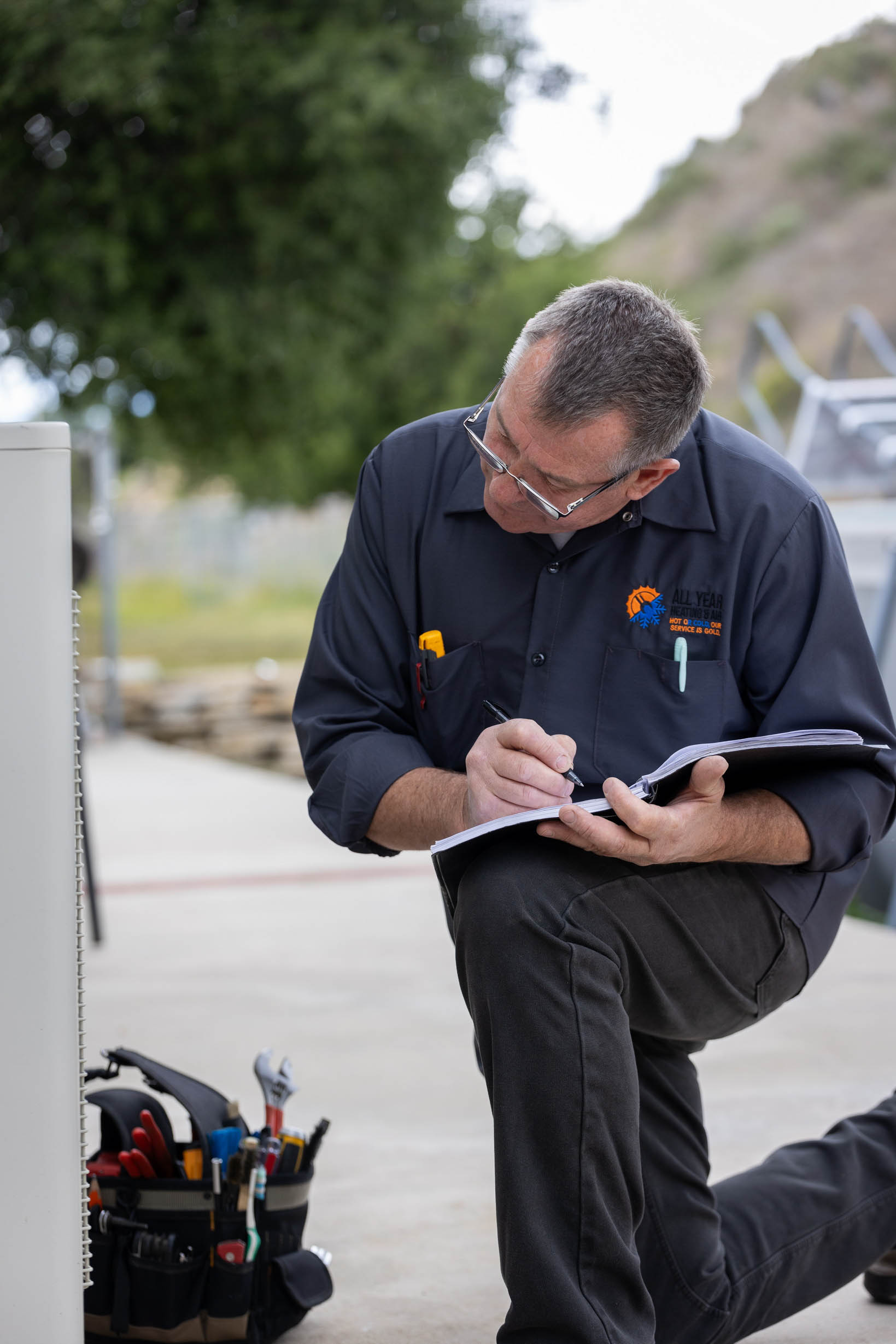 All Year technician documenting an AC system before installation
