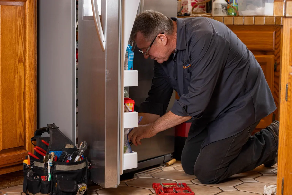 All Year technician diagnosing a side-by-side refrigerator-freezer in a Santa Clarita kitchen