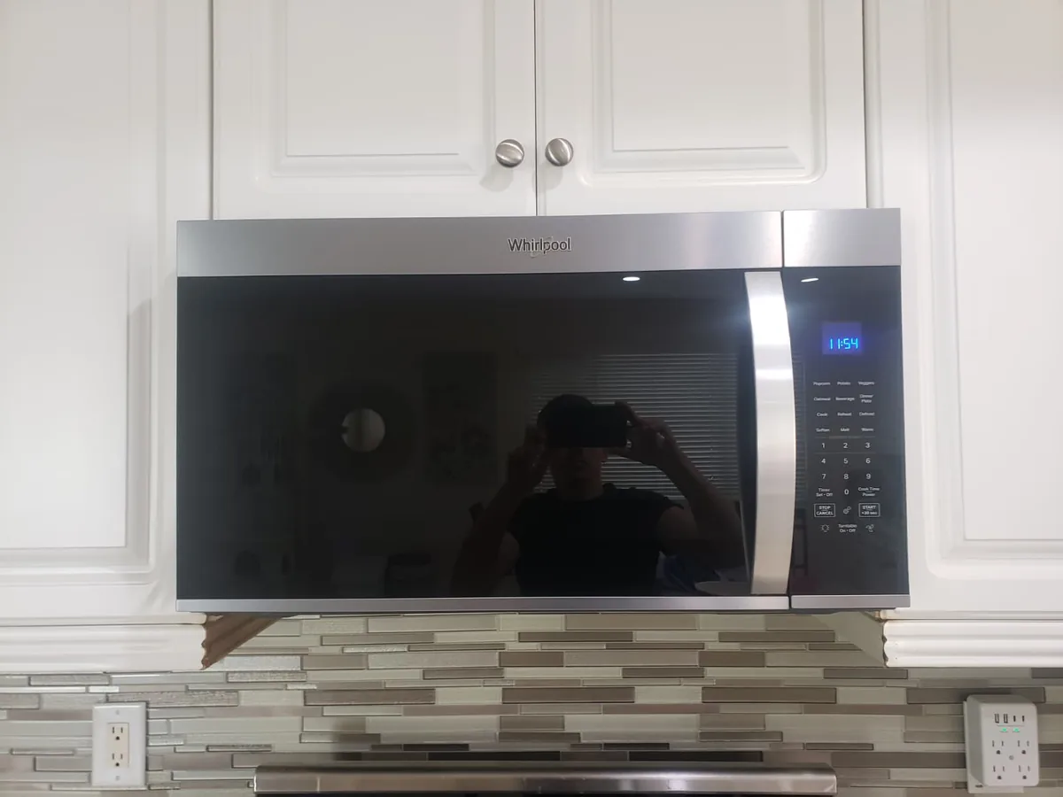 Finished over-the-range microwave installation above a kitchen range by All Year Heating & Air