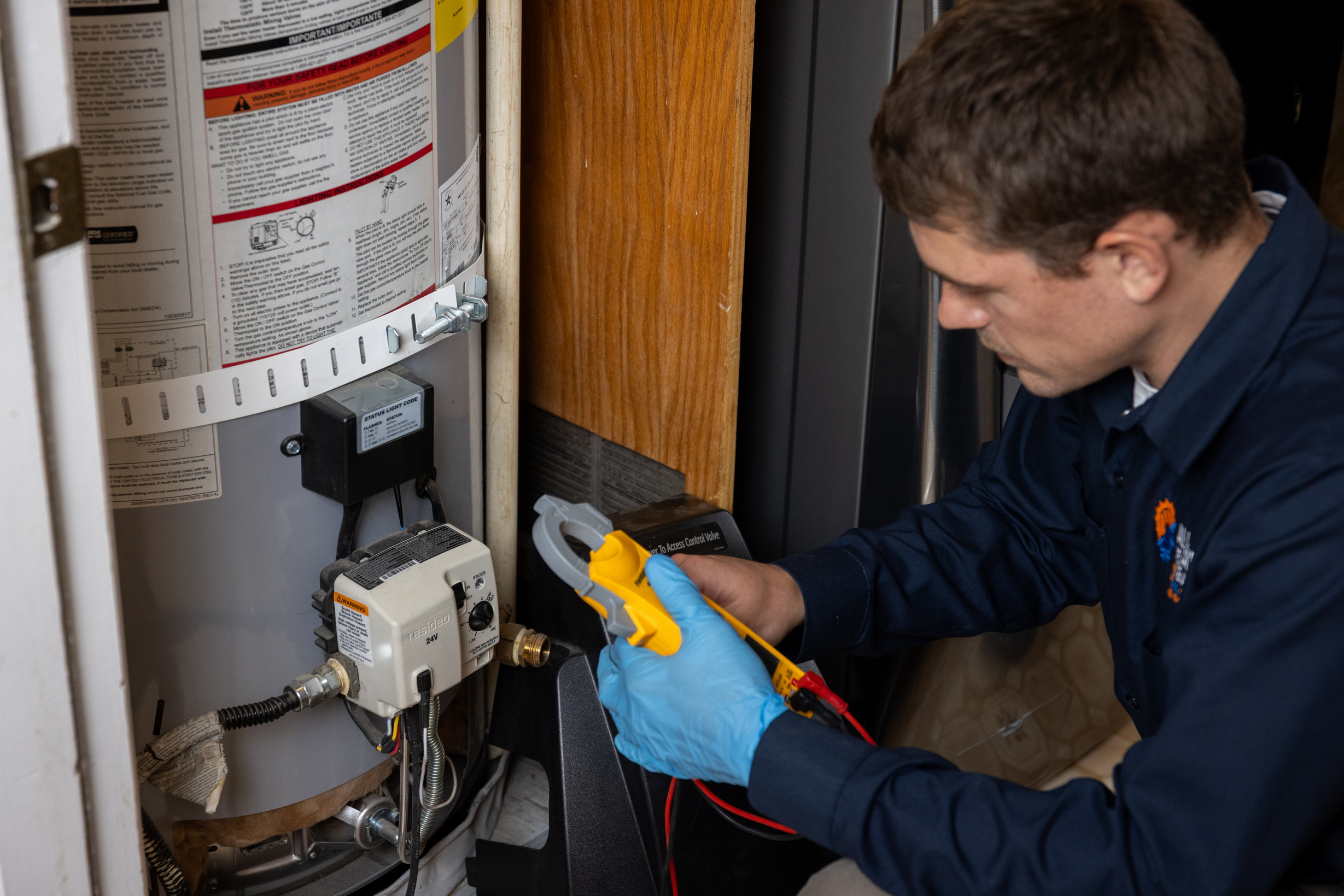 All Year Heating & Air technician diagnosing a residential gas water heater in Santa Clarita
